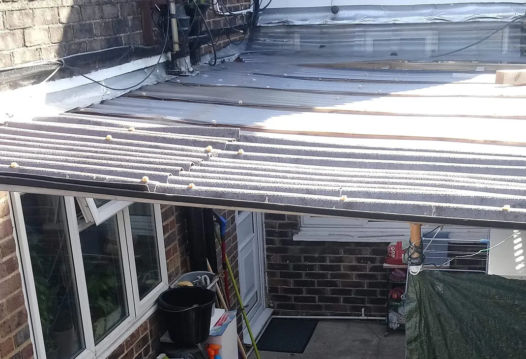 Old broken corrugated lean to roof